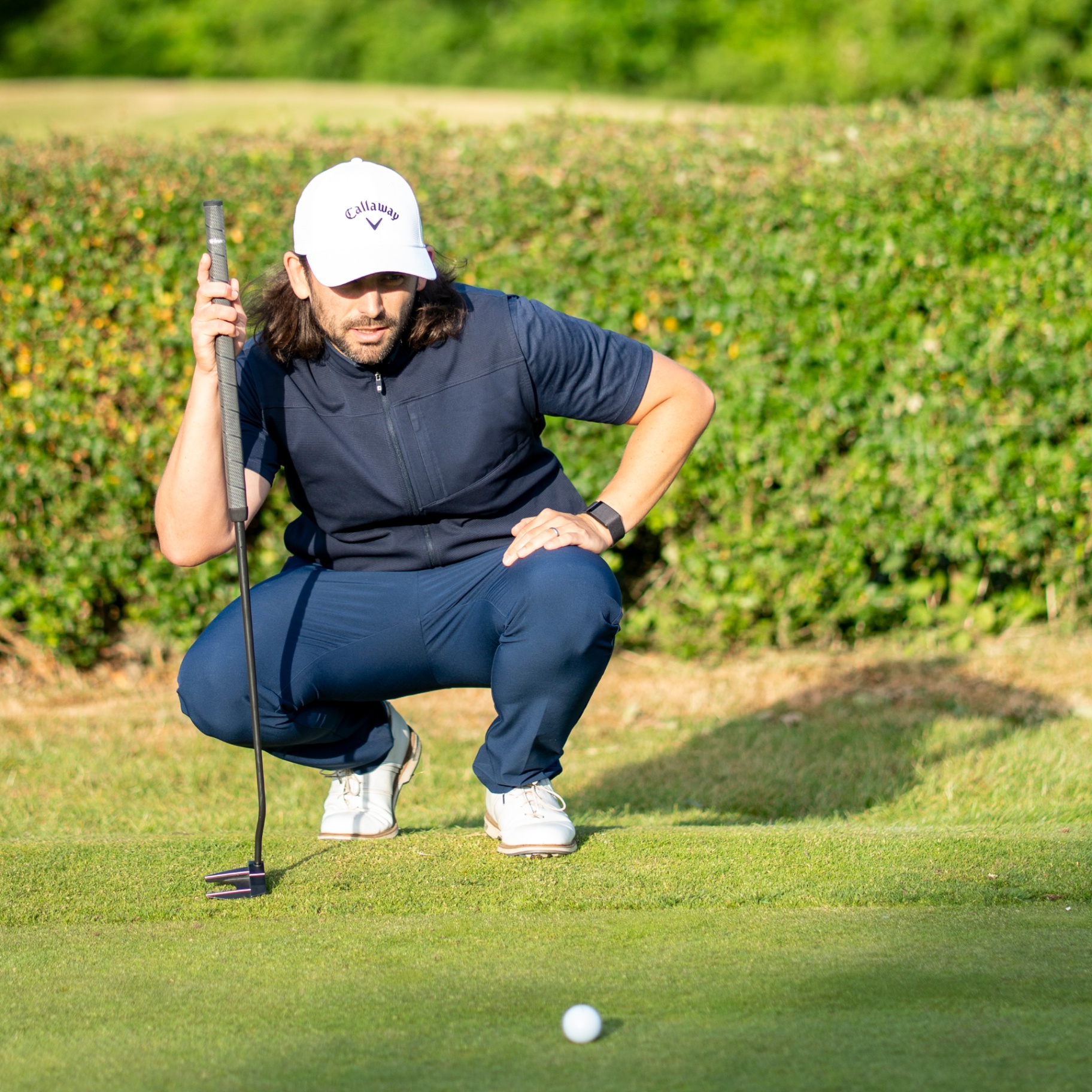 Golfer lining up a putt